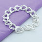 Silver chain bracelet on a purple fabric background