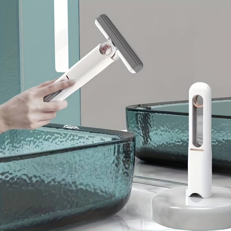 Hand using a cleaning tool on a glass surface with a second cleaning tool nearby.