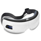 A white and black wireless digital eye massager with a small screen displaying blue LED lights, designed to be worn around the eyes for relaxation.