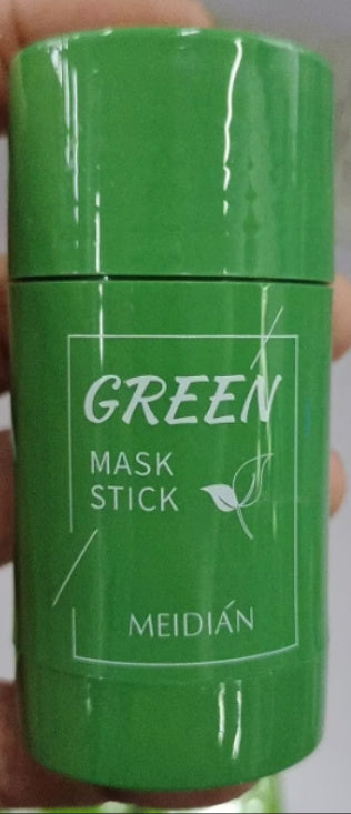 Green mask stick with 'MEIDI´N' branding held in a hand against a neutral background